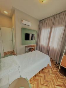 Ένα ή περισσότερα κρεβάτια σε δωμάτιο στο Paranaguá Lodge