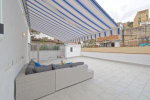a couch on the roof of a building at Bed&BCN Park Güell in Barcelona