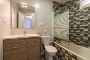 a bathroom with a toilet and a sink and a mirror at Bed&BCN Park Güell in Barcelona +30 photos