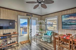 a living room with a television and a table and a chair at Walk to Beach Dog-Friendly Myrtle Beach Cottage! in Myrtle Beach