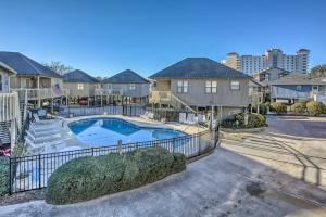 a villa with a swimming pool in a neighbourhood at Walk to Beach Dog-Friendly Myrtle Beach Cottage! in Myrtle Beach