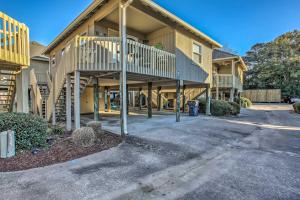 a large house with a staircase in front of it at Walk to Beach Dog-Friendly Myrtle Beach Cottage! in Myrtle Beach