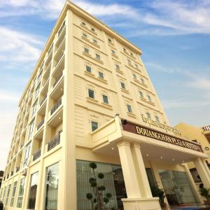 a large white building with a sign on it at Douangchan Plaza Hotel in Vientiane