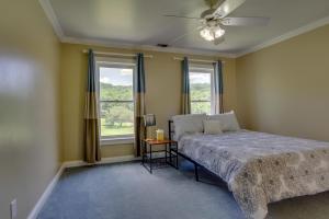 a bedroom with a bed and two windows at Country Cove in Brentwood