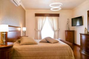 a bedroom with a large bed and a window at Solar Do Douro in Santa Cruz do Douro +30 photos