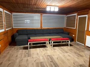 a living room with a blue couch and two benches at Villa Euphoria in Bersin