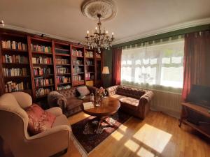 a living room filled with furniture and a chandelier at Ferienwohnung Burgzauber in Wiltingen