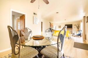 a dining room with a glass table and chairs at Misha’s HunnHaven in Yuba City