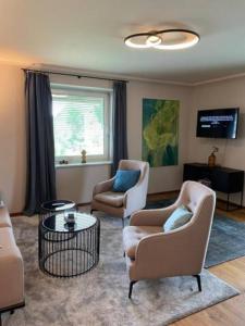 Una sala de estar con dos sillas y una mesa. en Großzügiges, charmantes Appartement in Salzburg by Fiorentino, en Salzburgo