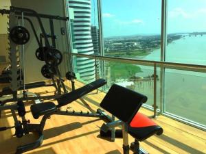 a gym in a building with a view of the water at Ecusuites Riverfront l Balcony in Guayaquil