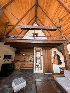 a large room with a wooden ceiling with a cross at Elia Loft in Stepantsminda