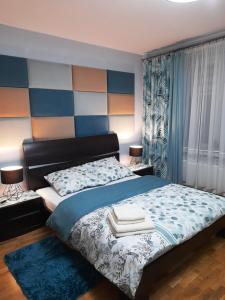 a bedroom with a bed with towels on it at Tu się śpi in Bodzentyn