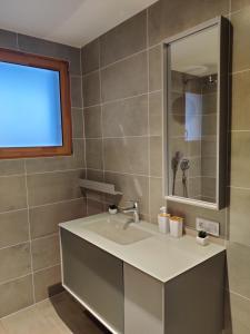 a bathroom with a sink and a mirror at Appartement du parc des thermes in Thonon-les-Bains +9 photos