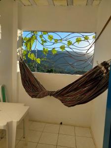a hammock hanging from a window in a room at Pousada da Lurdinha in Lençóis
