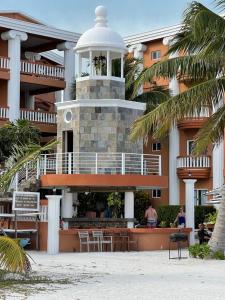 a building with a clock tower in front of it at Lighthouse Beach Villas in San Pedro