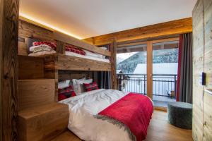 a bedroom with a bunk bed and a window at Berghof Penthouse in Saas-Fee