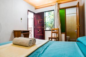 A bed or beds in a room at Galapagos Dove