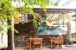 a group of tables and chairs under a pergola at Galapagos Dove in Puerto Ayora