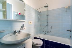 a bathroom with a sink and a toilet and a shower at La Casetta in Tremezzo +22 photos