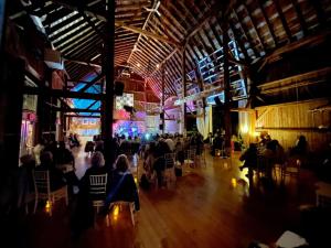 a group of people sitting in a large building at The Eddie Hotel and Farm in Bloomfield