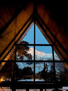 a window in a roof with a view of a mountain at Elia Loft in Stepantsminda