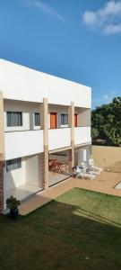 a rendering of a building with chairs and a yard at Pousada Reobote in São Miguel do Gostoso