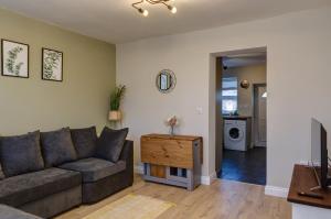 a living room with a couch and a table at Cosy 2 bed home CHESTERFIELD in Chesterfield
