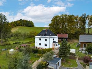 an aerial view of a white house in a field at Ferienwohnung Erzgebirgswohnung Götze in Glashütte