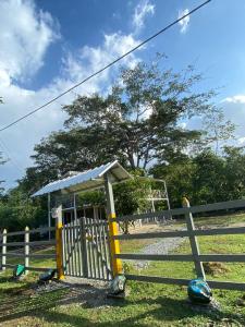 a fence with a gate and a soccer field at Casa de Vacaciones ECOWASI VERAS in Capurganá