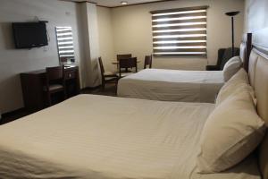 Postel nebo postele na pokoji v ubytování Hotel Adriana