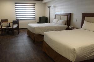 Postel nebo postele na pokoji v ubytování Hotel Adriana