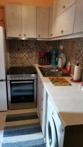 a kitchen with a sink and a stove at •Budget travellers •Great location in Athens