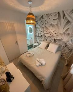 a bedroom with a bed with towels on it at L'extasia appartement,spa jacuzzi Grenoble in Grenoble