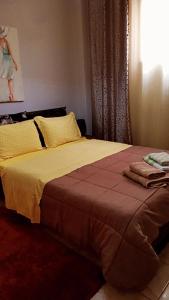 a bedroom with a bed with yellow sheets and a window at •Budget travellers •Great location in Athens