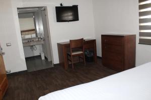 Postel nebo postele na pokoji v ubytování Hotel Adriana