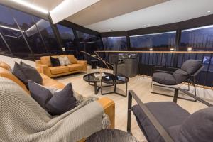 a living room with couches and chairs on a yacht at All Seasons Houseboats in Mildura