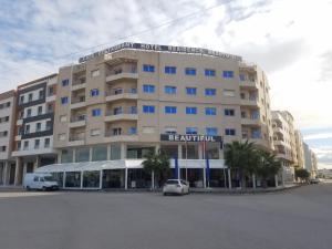 a large building with a car parked in front of it at HOTEL BEAUTIFUL in Nador