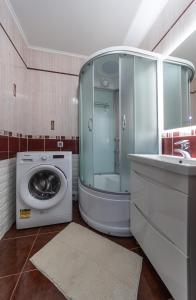 a bathroom with a washing machine and a sink at Modern 3 bedroom apartment in Kyiv +18 photos