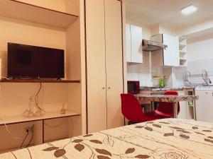 een slaapkamer met een bed en een tafel en een keuken bij Depto 2 Metro Cal y Canto (Estudio) in Santiago