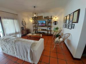 a living room with a couch and a tv at Casa del buen recuerdo San Lorenzo -SALTA- in San Lorenzo