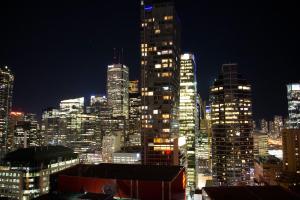 a night view of a city with tall buildings at Downtown High-rise Condo- CN Tower View in Toronto
