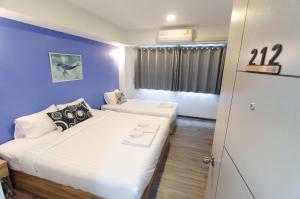 Postel nebo postele na pokoji v ubytování Bleu Marine Sattahip Hotel