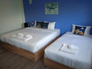 Postel nebo postele na pokoji v ubytování Bleu Marine Sattahip Hotel