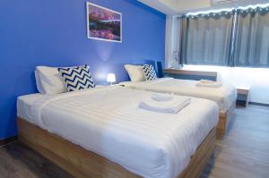 Postel nebo postele na pokoji v ubytování Bleu Marine Sattahip Hotel
