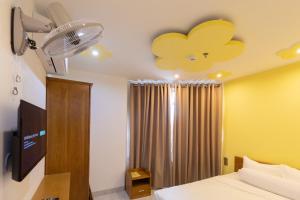 a bedroom with a bed with a flower ceiling at 26 Topaz Hotel in Vung Tau