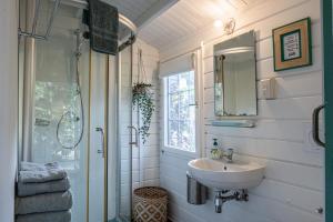 a bathroom with a sink and a shower at OTRO Curaçao - Urban Oasis in Otrobanda in Willemstad +18 photos