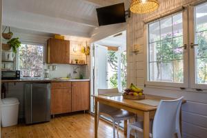 a small kitchen with a wooden table and chairs at OTRO Curaçao - Urban Oasis in Otrobanda in Willemstad