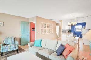 a living room with a couch and a kitchen at The Beach Escape in Clearwater Beach