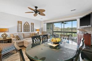 a living room with a table and a couch at Seascape Lakefront Villas 232 in Destin