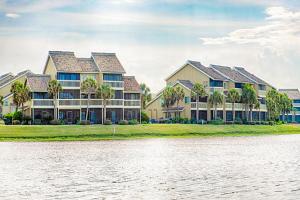 a row of houses by the water at Seascape Lakefront Villas 232 in Destin